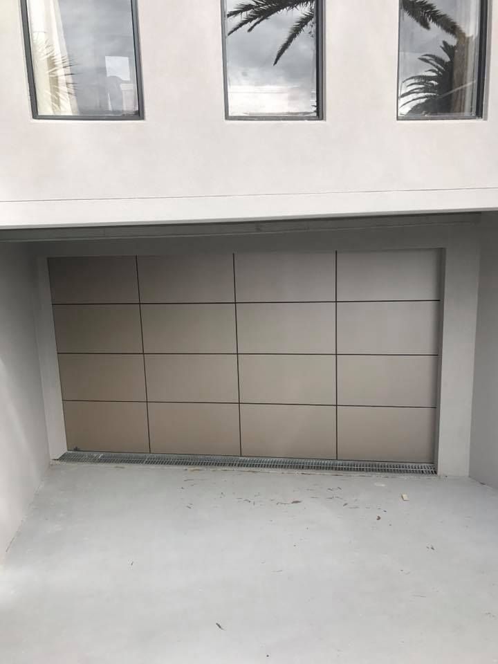 There is a garage door in the middle of a building.