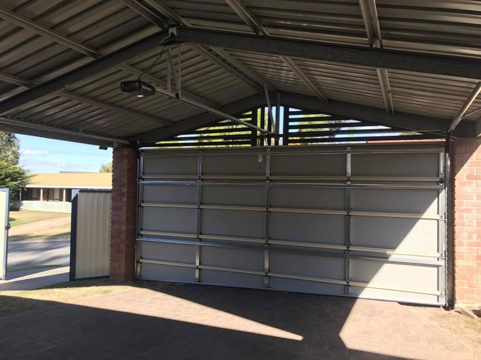 A garage door with a canopy over it is open.