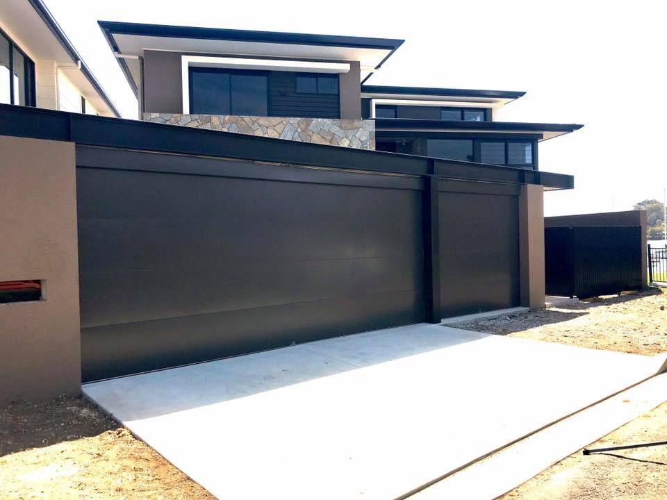 A large house with a large black garage door