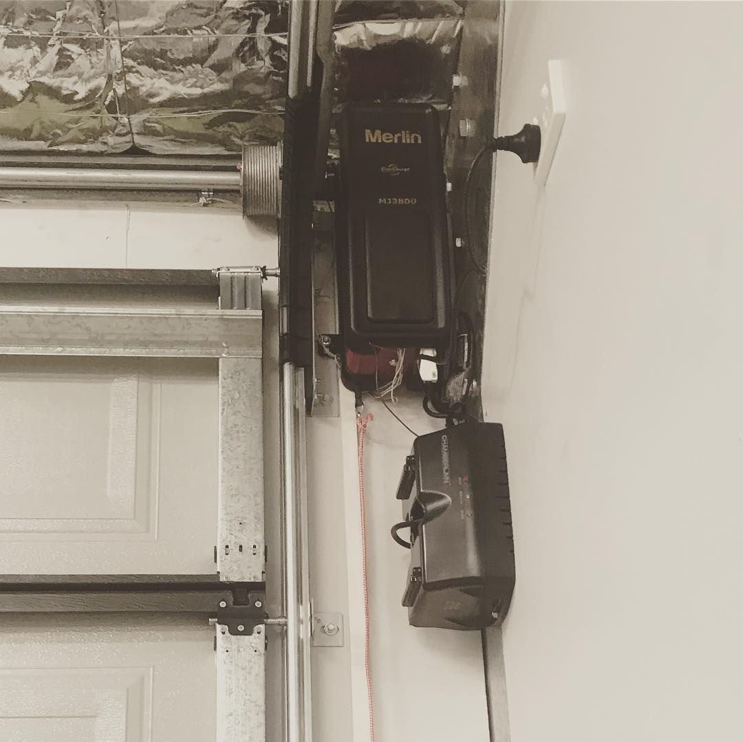 A black and white photo of a garage door opener.