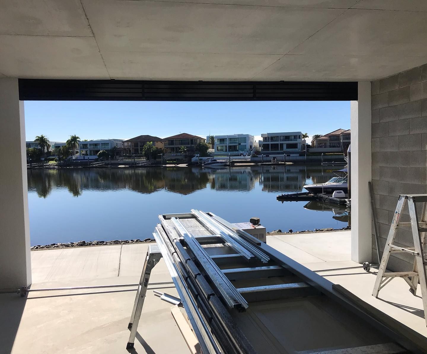 A ladder is sitting in front of a large body of water