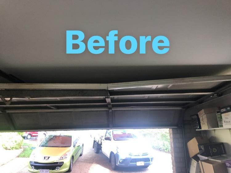 A picture of a garage door before being repaired