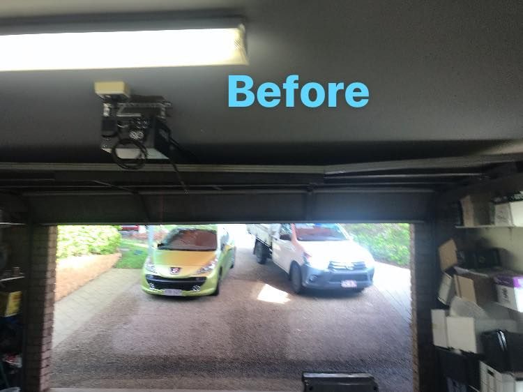 A before picture of a garage with cars parked in it