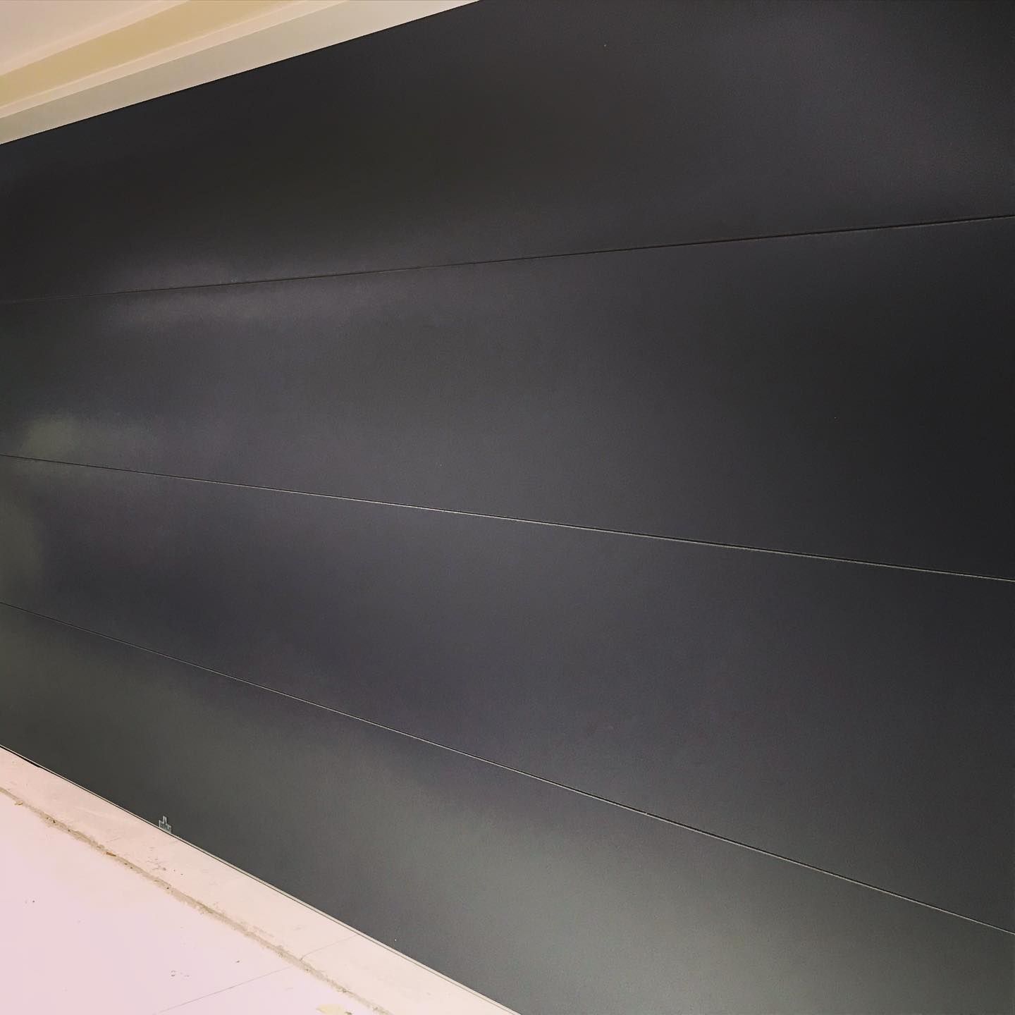 A black wall with white lines on it