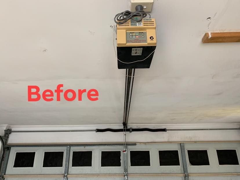 A picture of a garage door opener before being repaired