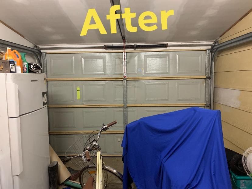 A garage with a bicycle and a refrigerator and a sign that says after