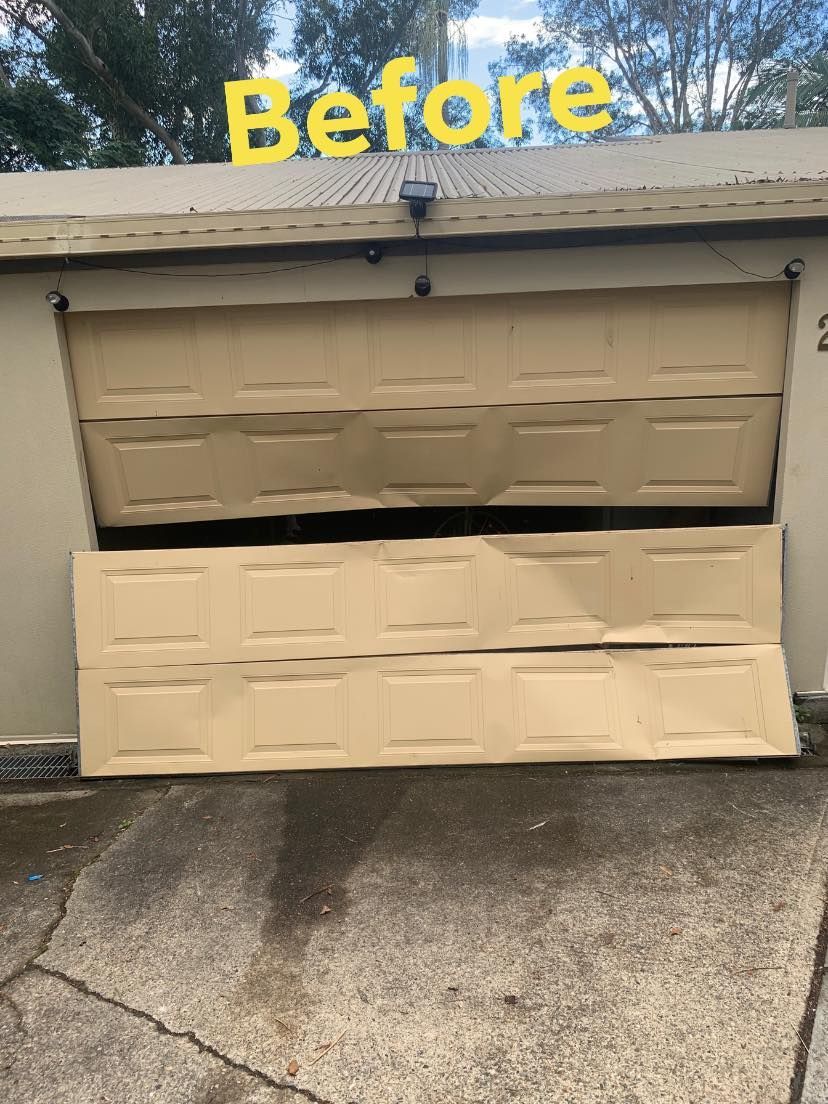 A picture of a garage door before being repaired.