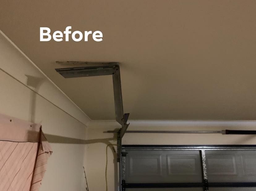 A picture of a garage door before being repaired