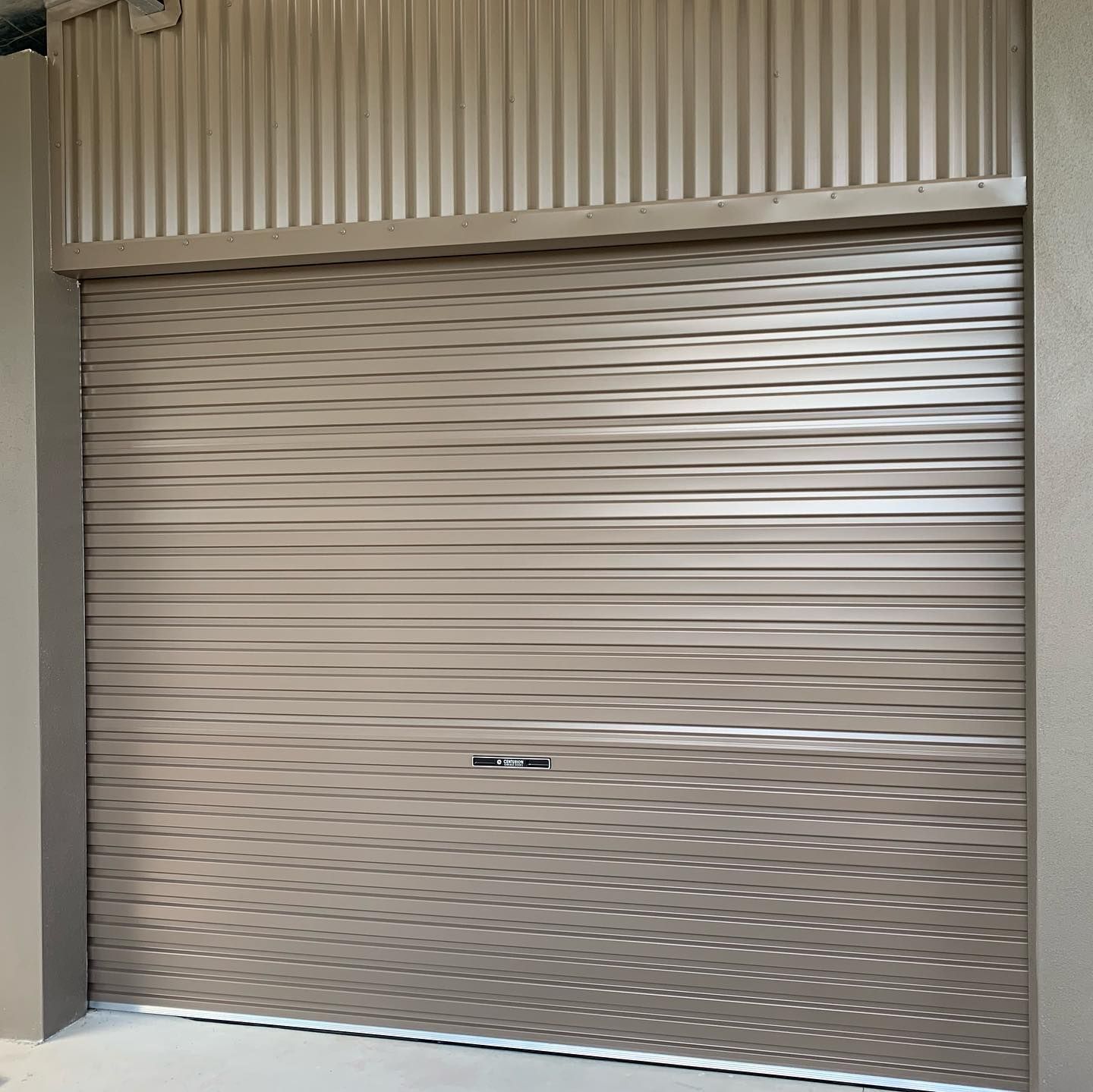 A close up of a garage door with a metal wall behind it.