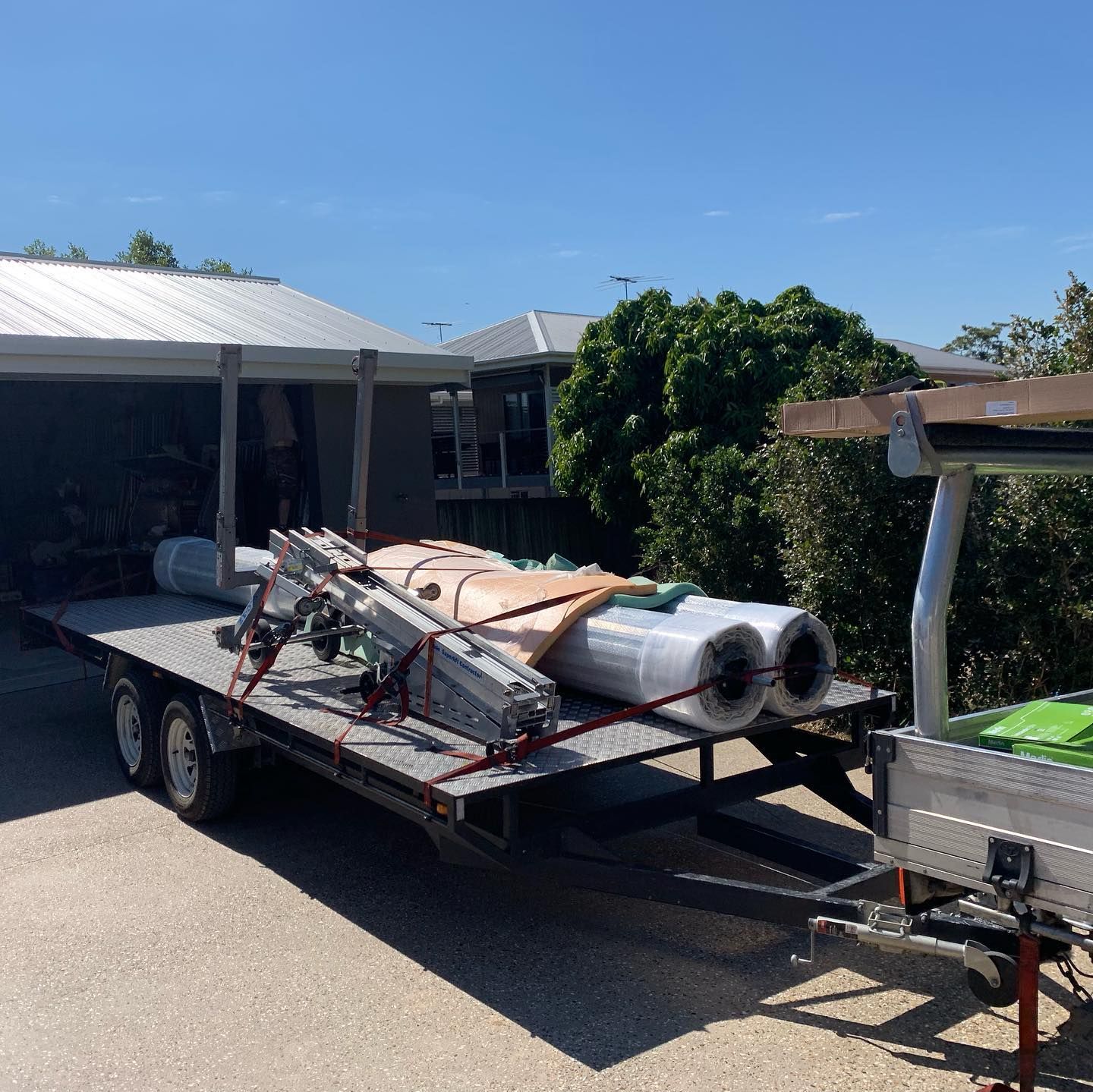 A trailer with a bunch of rolls of plastic on it