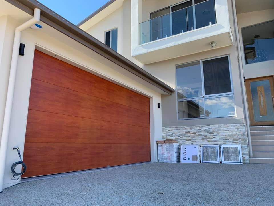 A large house with a large red garage door
