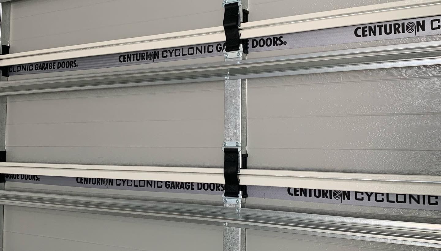 A close up of a garage door with centurion cyclone doors written on it.