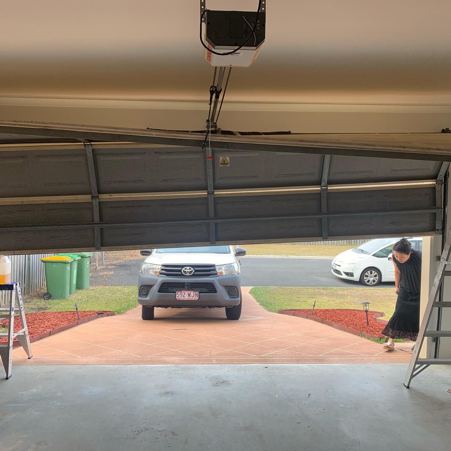 A car is parked in a garage with the door open.