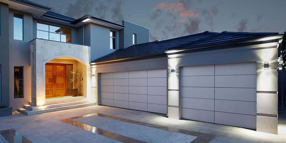 A large house with two garage doors in front of it.