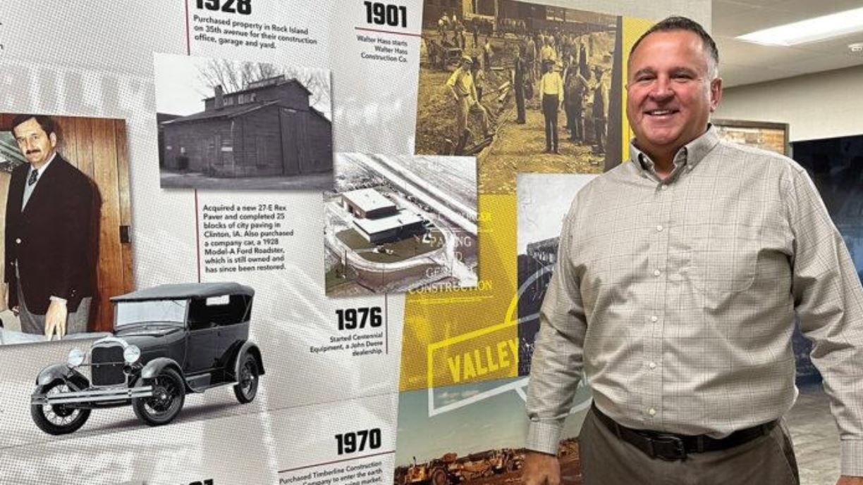 President and CEO Greg Haas stands by company history display.