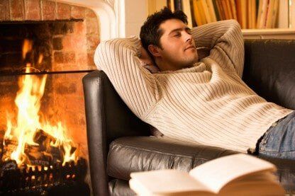 Man relaxing near the fireplace - Fireplace in Lake George, NY