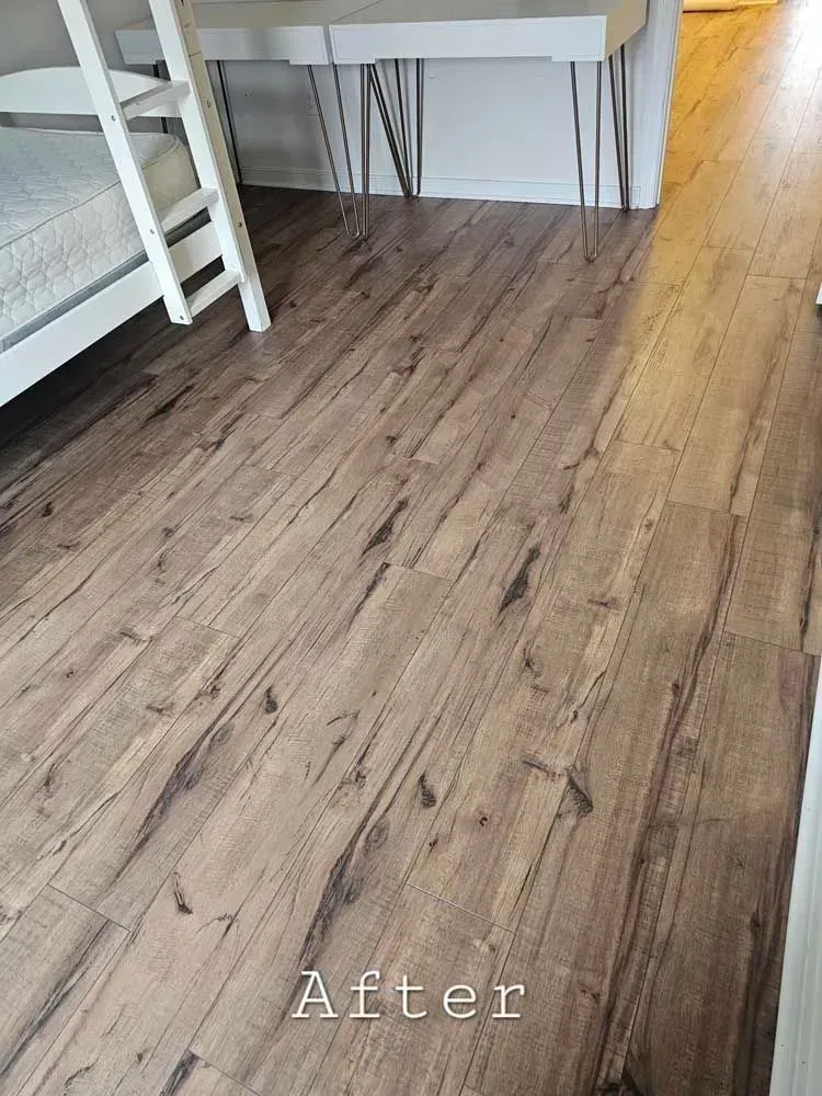 Wood-look flooring in a room with a white bunk bed and a desk with hairpin legs.