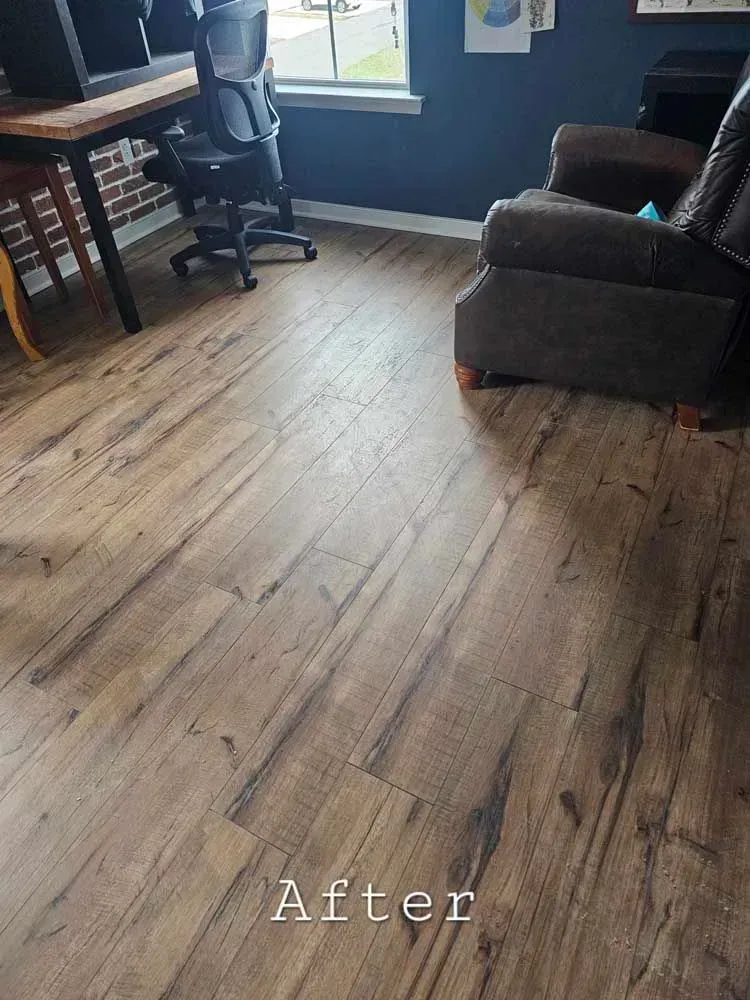Wooden floor in a room with a desk, chair, and armchair, labeled 