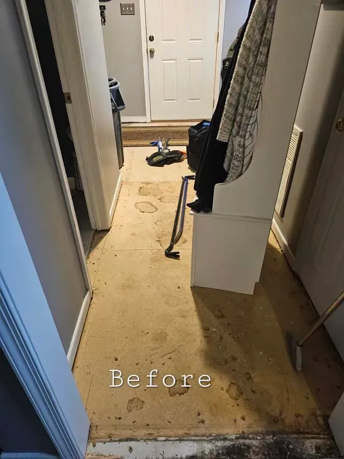 Entryway with stained flooring, visible door and light fixtures, 