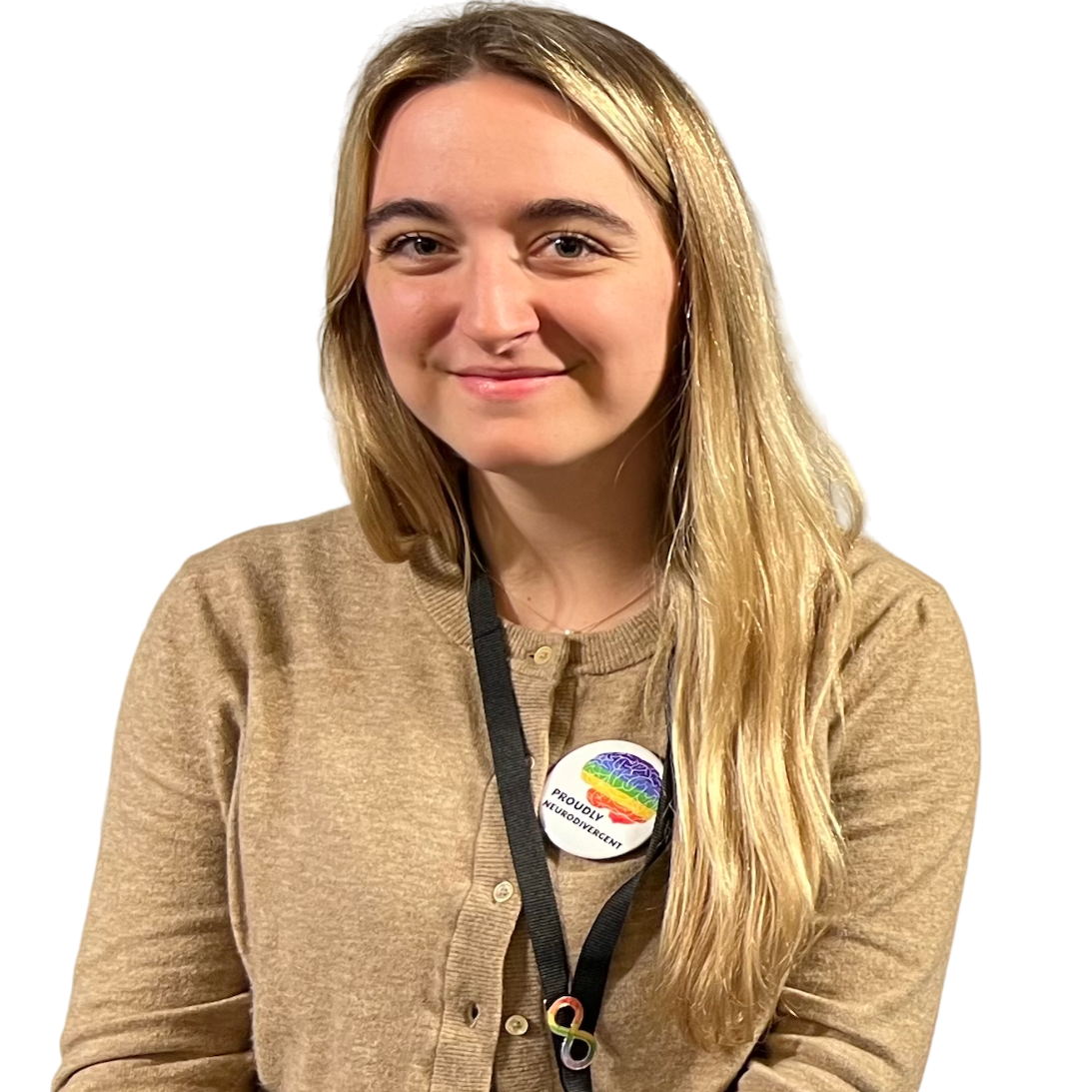 A woman wearing a light brown cardigan is smiling for the camera.