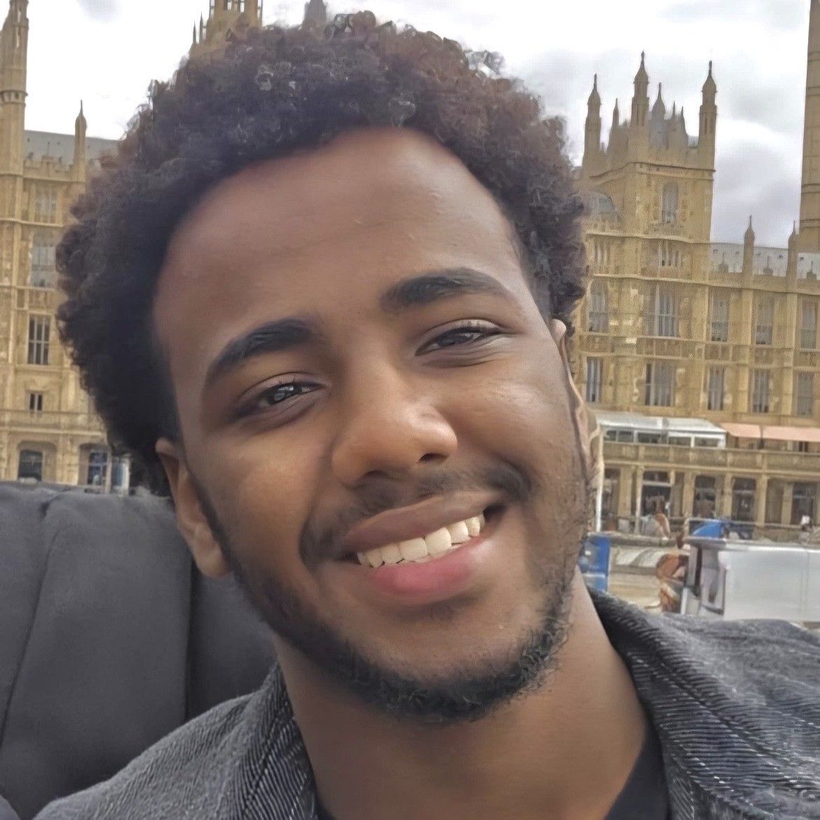 A man with a short beard is smiling for the camera.