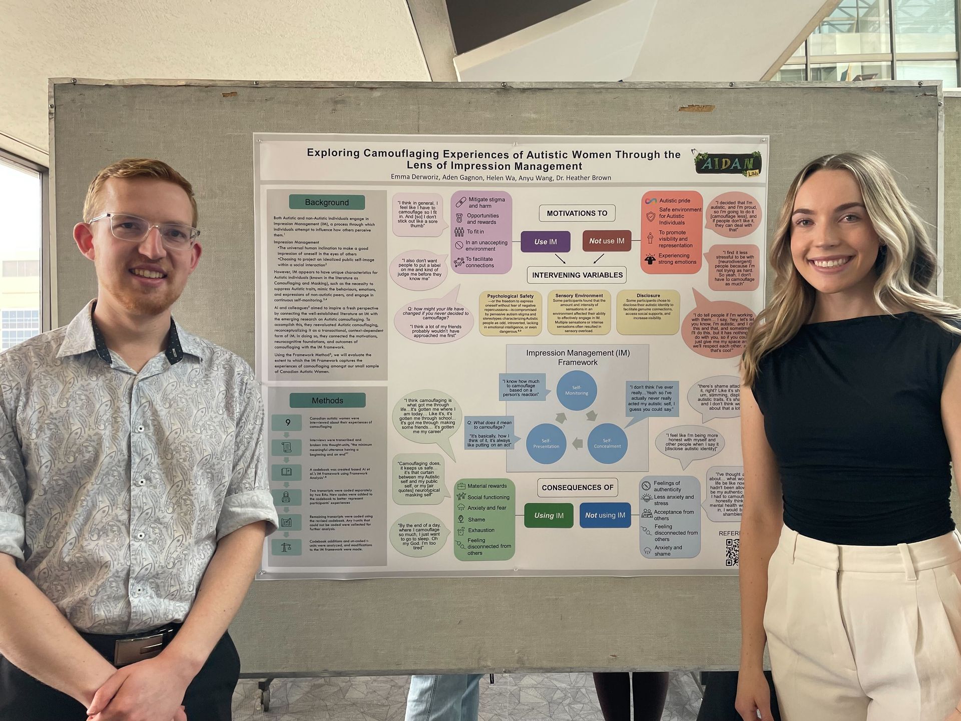 A man and a woman are giving a presentation in front of a large screen in a classroom.