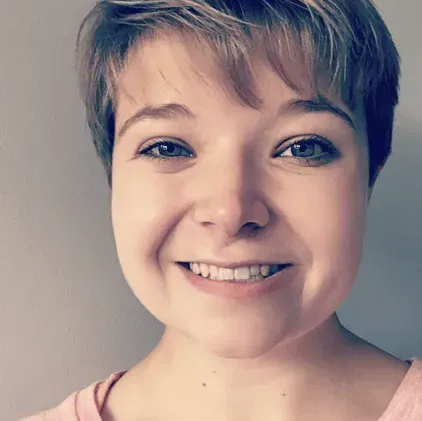 A woman with short hair is smiling for the camera.