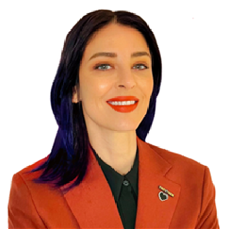 A woman with purple hair is wearing an orange jacket