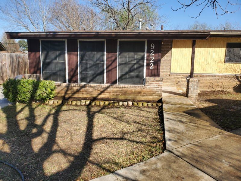 The front of a house with a walkway leading to it.