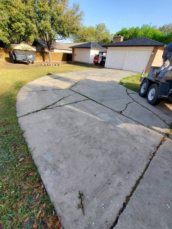 A golf cart is parked in a driveway next to a house.