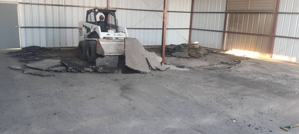 A bulldozer is sitting in the middle of a warehouse.