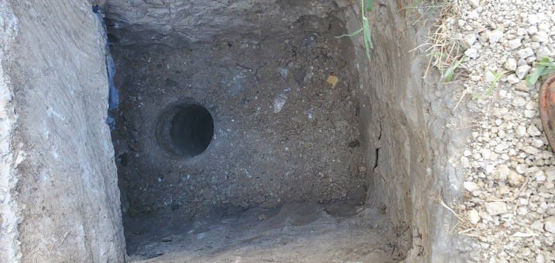 A hole in the ground with a hole in the middle of it.