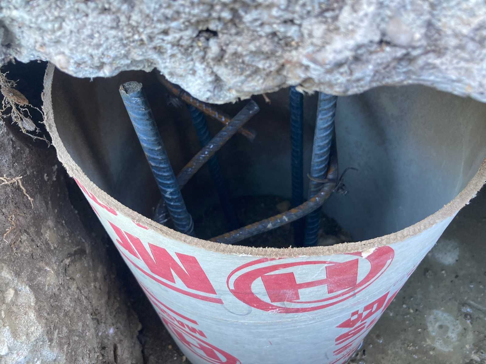 A concrete pipe with the letter h on it