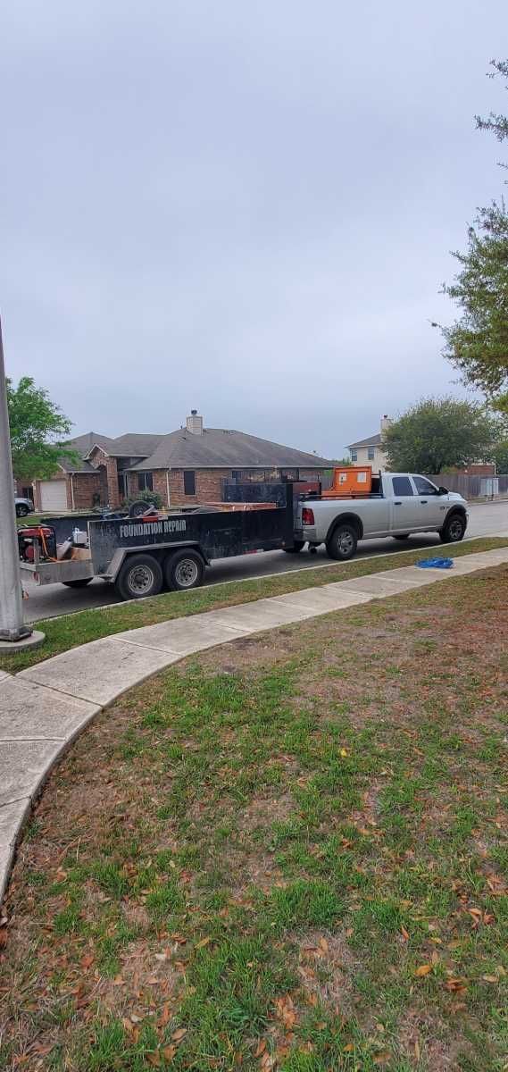 A truck with a trailer attached to it is parked on the side of the road.