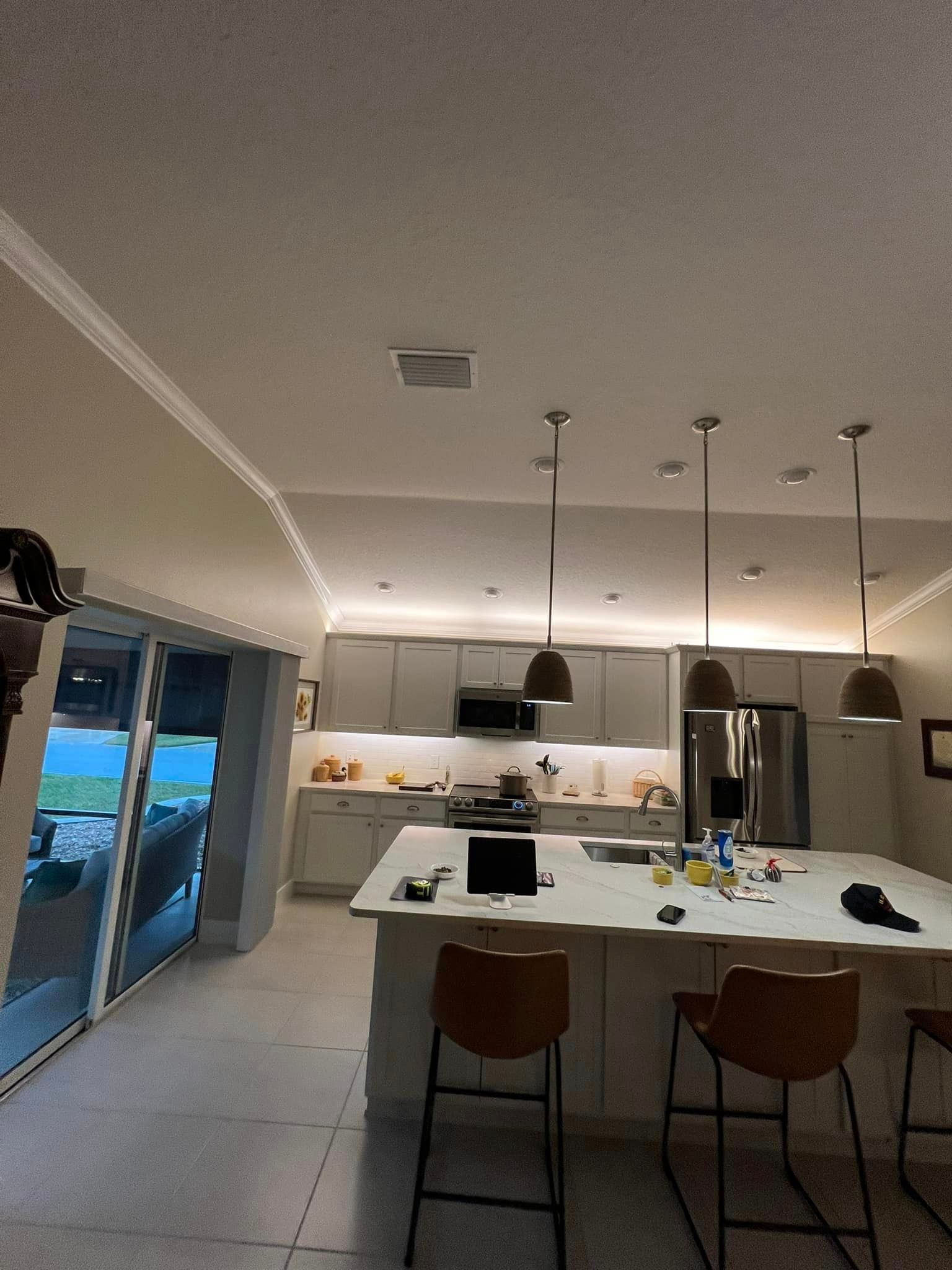 A kitchen with a large island and stools