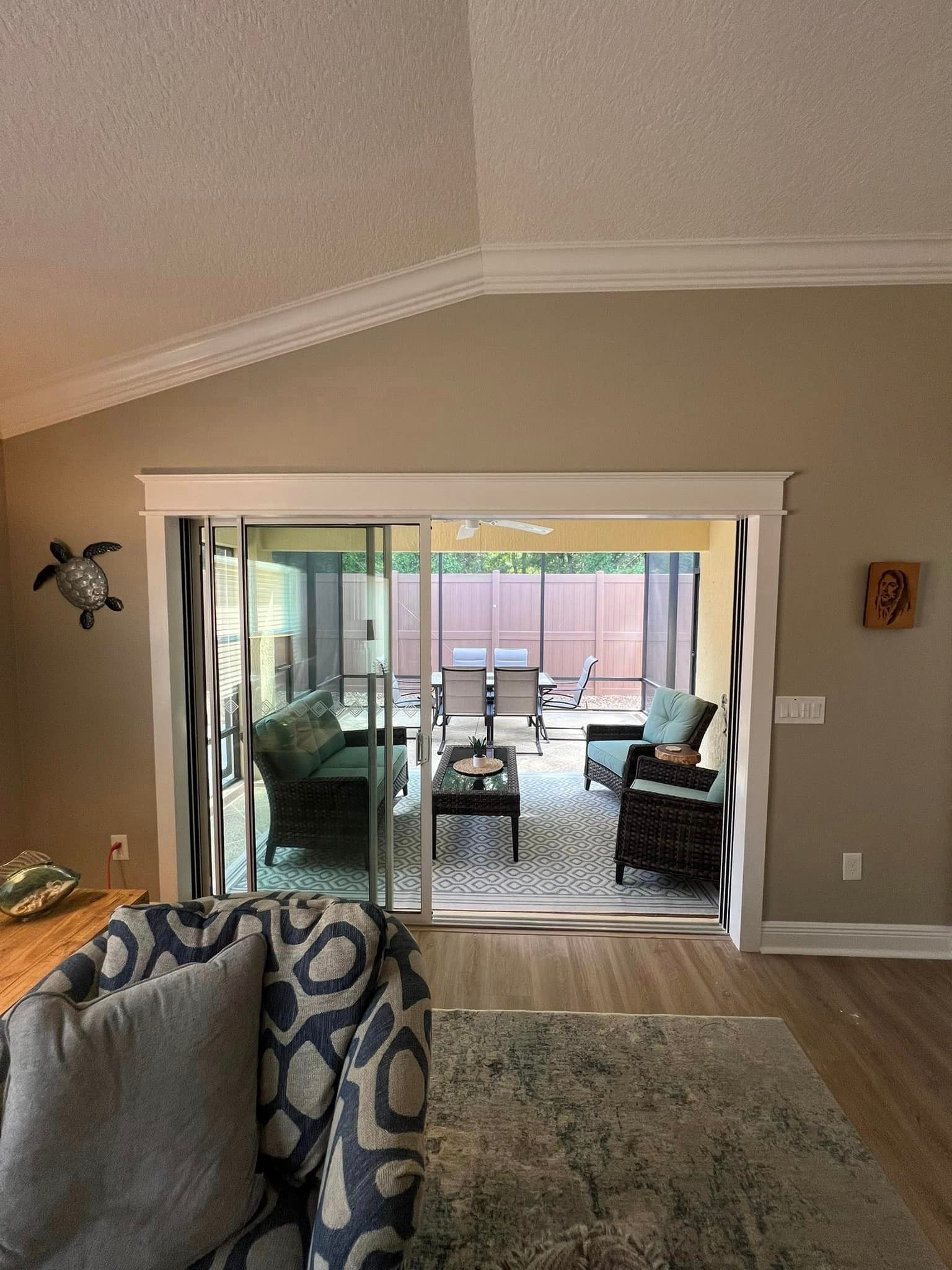 A living room with sliding glass doors leading to a patio.