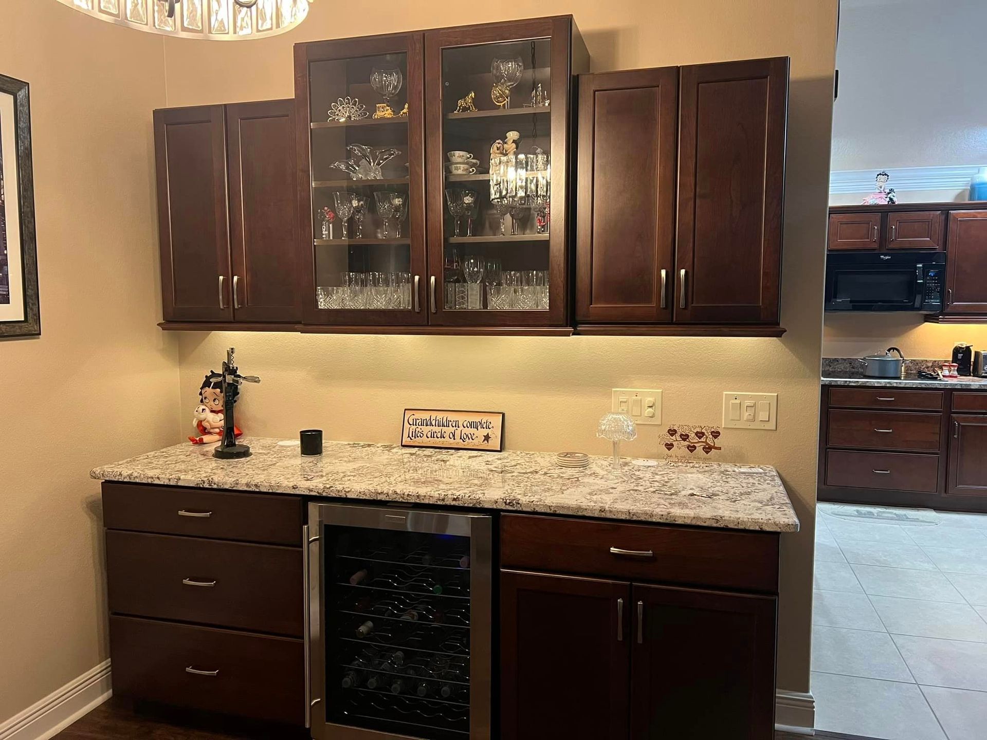 A kitchen with wooden cabinets and a wine cooler
