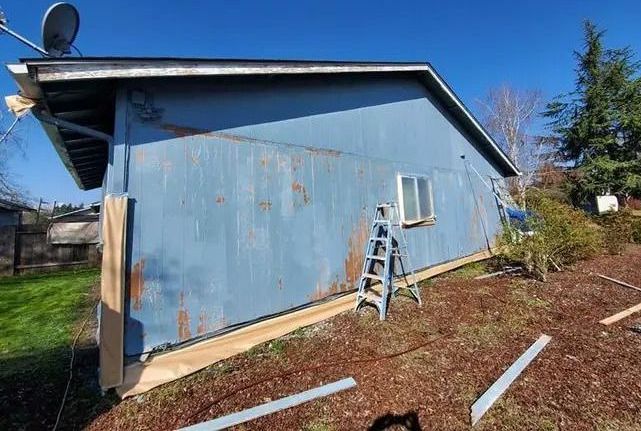 House exterior with visible wear and tear before painting service