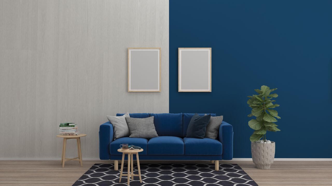 Blue sofa in room with white and blue wall.