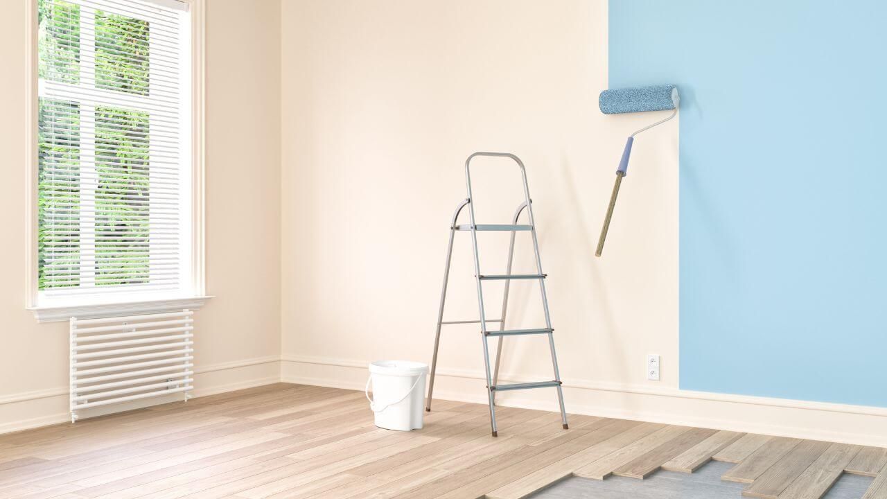 Room featuring blue walls and ladder.