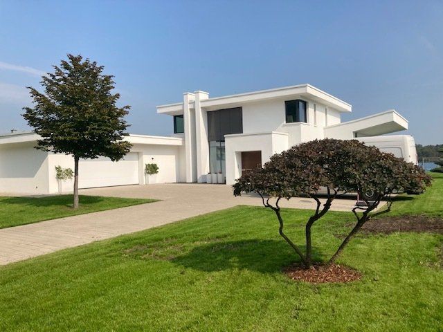 Ein großes weißes Haus mit einem Baum davor