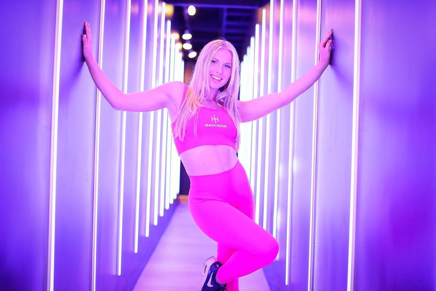 A man and a woman are holding a heart in front of their faces.