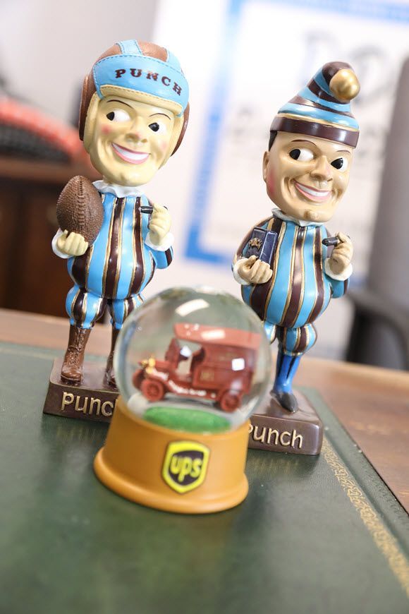 Two ups bobbleheads and a ups snow globe on a table