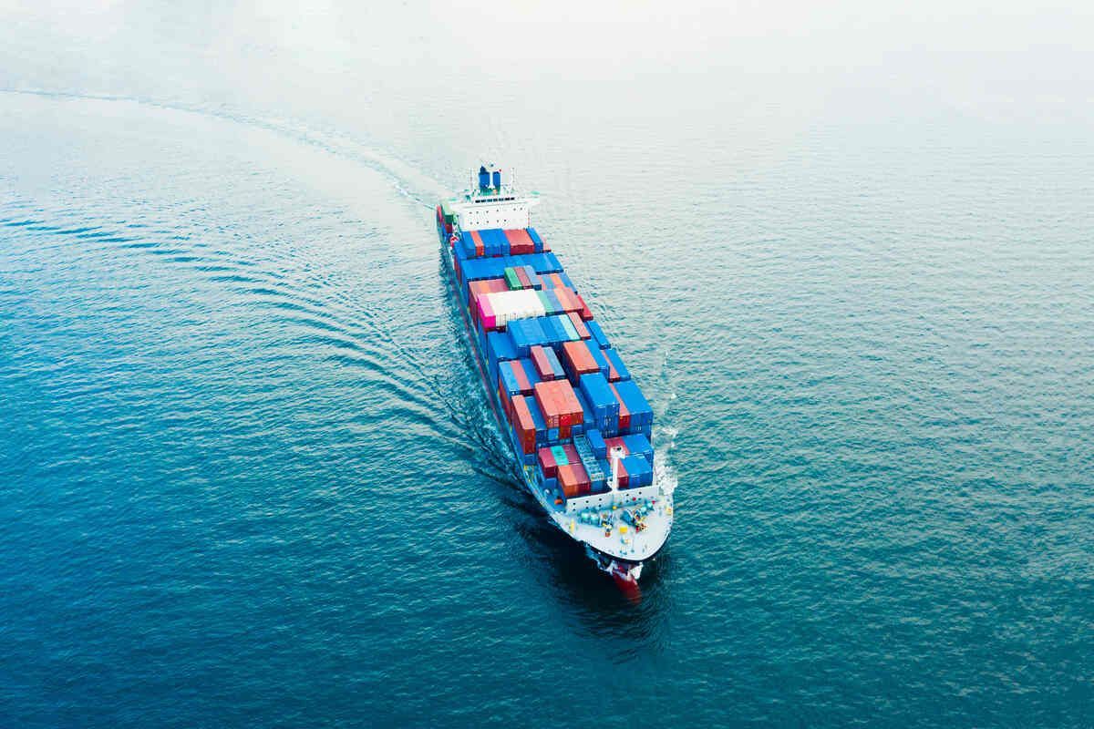 An aerial view of a large container ship floating on top of a body of water.