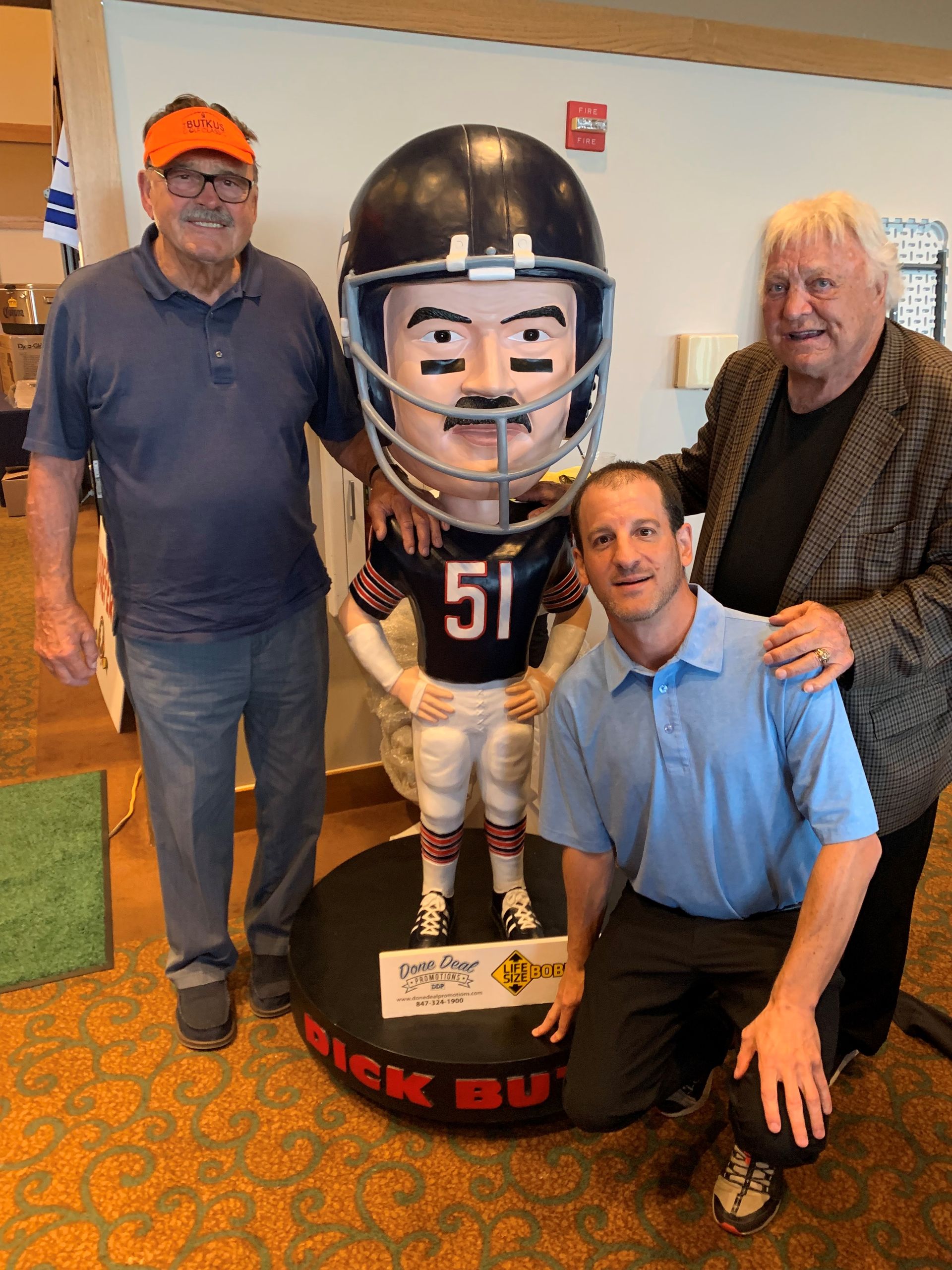 A shelf filled with bottles of liquor and cups stacked on top of each other.