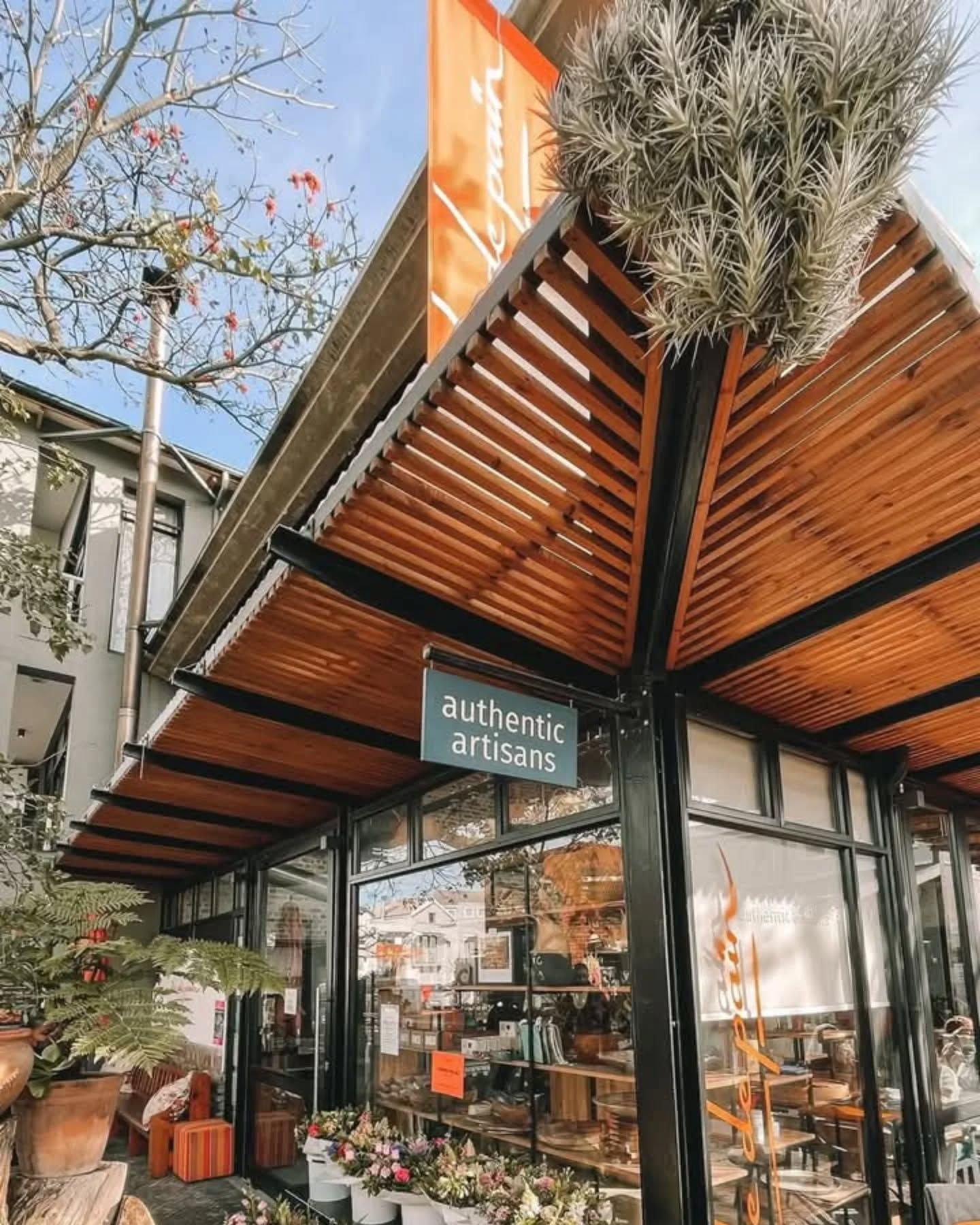Shopfront with a wooden slatted awning and sign that says