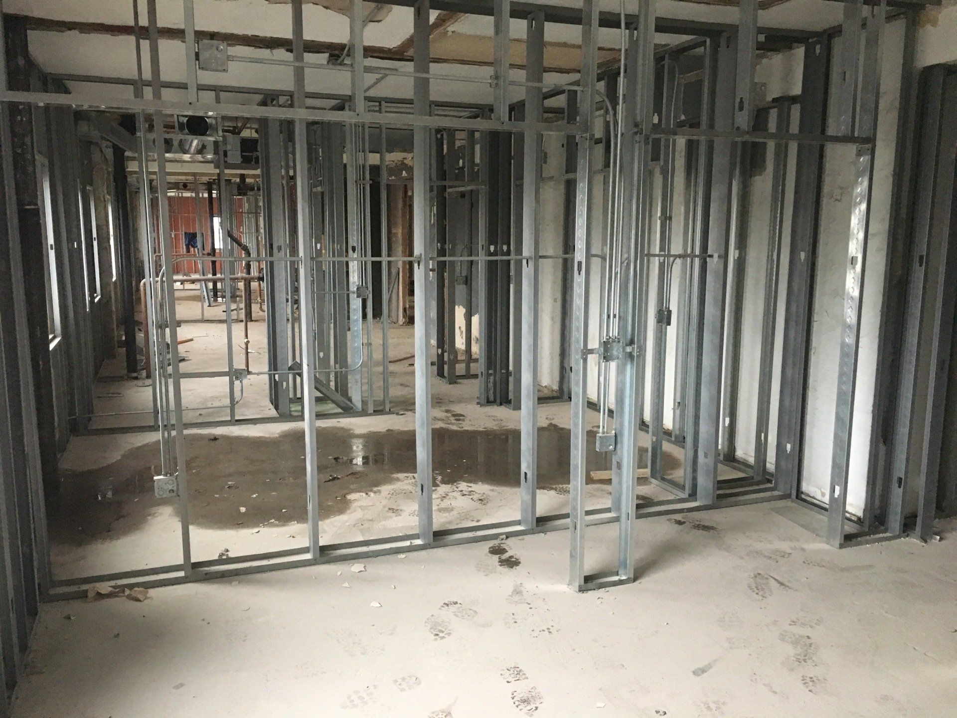 Metal studs forming interior walls in a building under construction.
