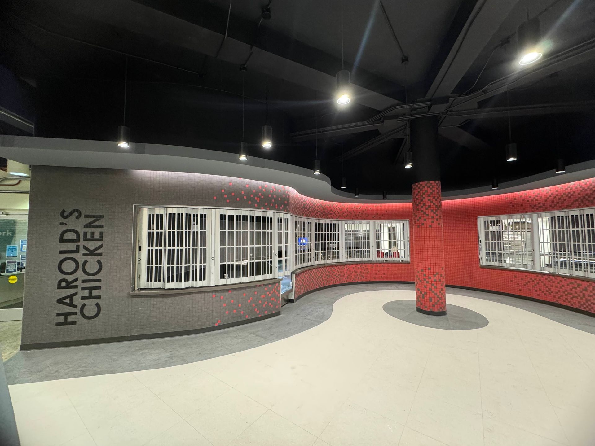 Interior finished with curved counter, windows, and red brick wall.