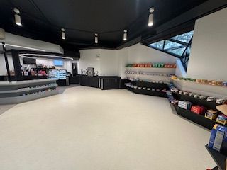 Empty convenience store interior with snacks and a coffee bar. UIC