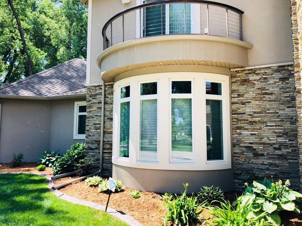 a large house with a large bay window and a balcony .